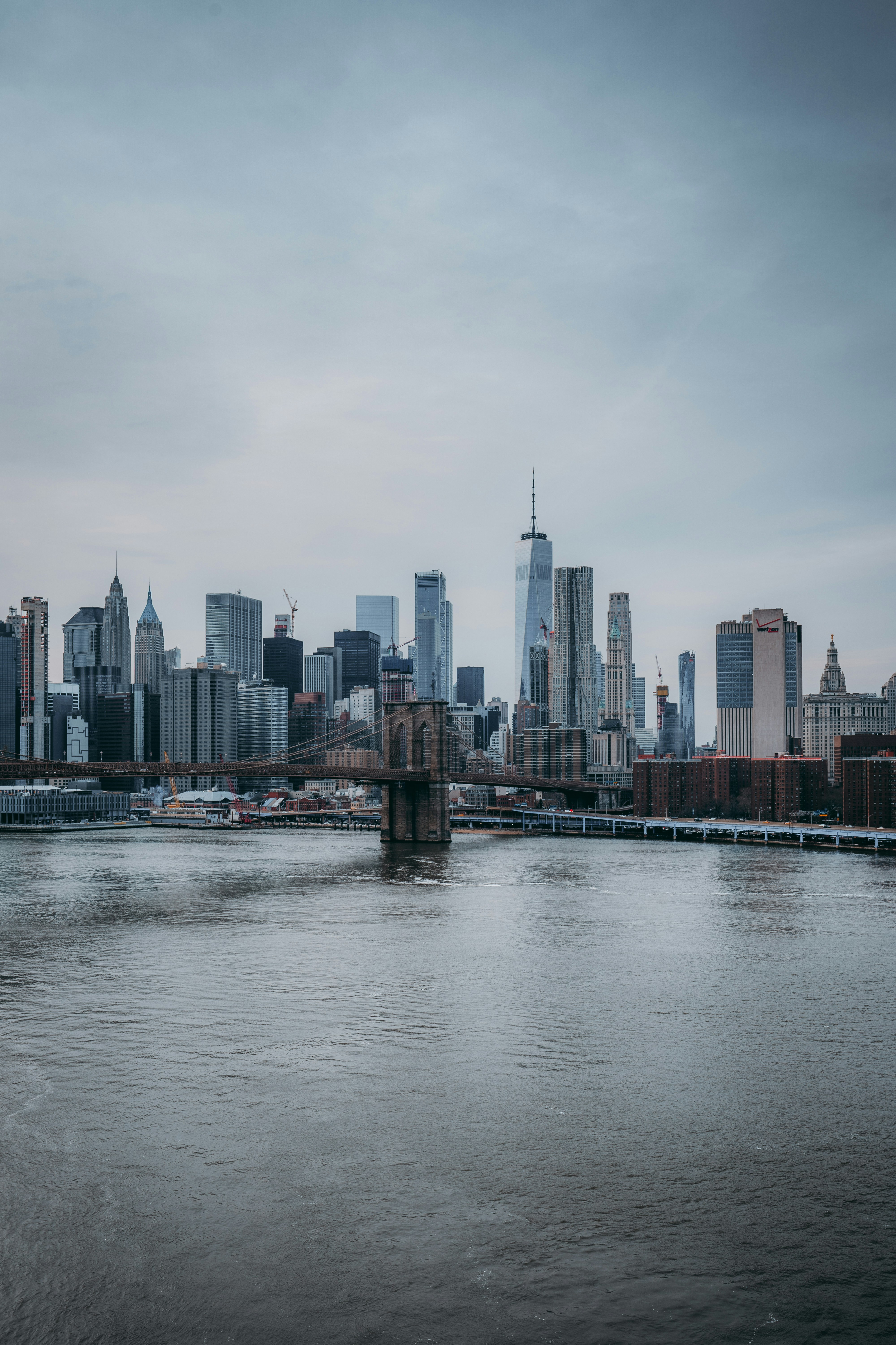 New York City skyline with Brooklyn Bridge and One World Trade Center viewed across the East River